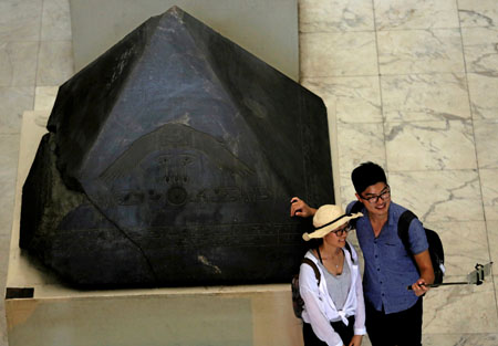 Tourists walk around pharaonic artefacts inside the Egyptian Museum in Cairo, Egypt, on June 23 (Reuters photo)